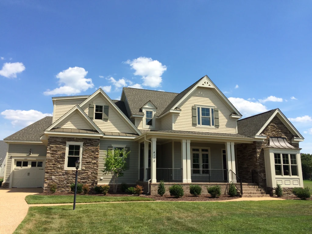 Bucknell Place, a tan custom home with a stone-accented front porch